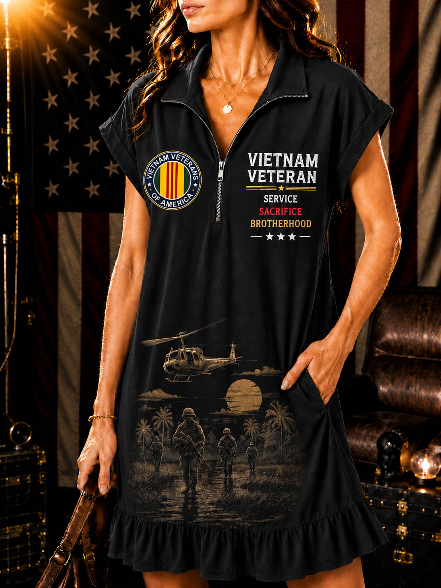 A woman wearing a black ruffled mini dress with a half-zip collar and Vietnam Veteran themed graphics, posed in front of an American flag and leather furniture.