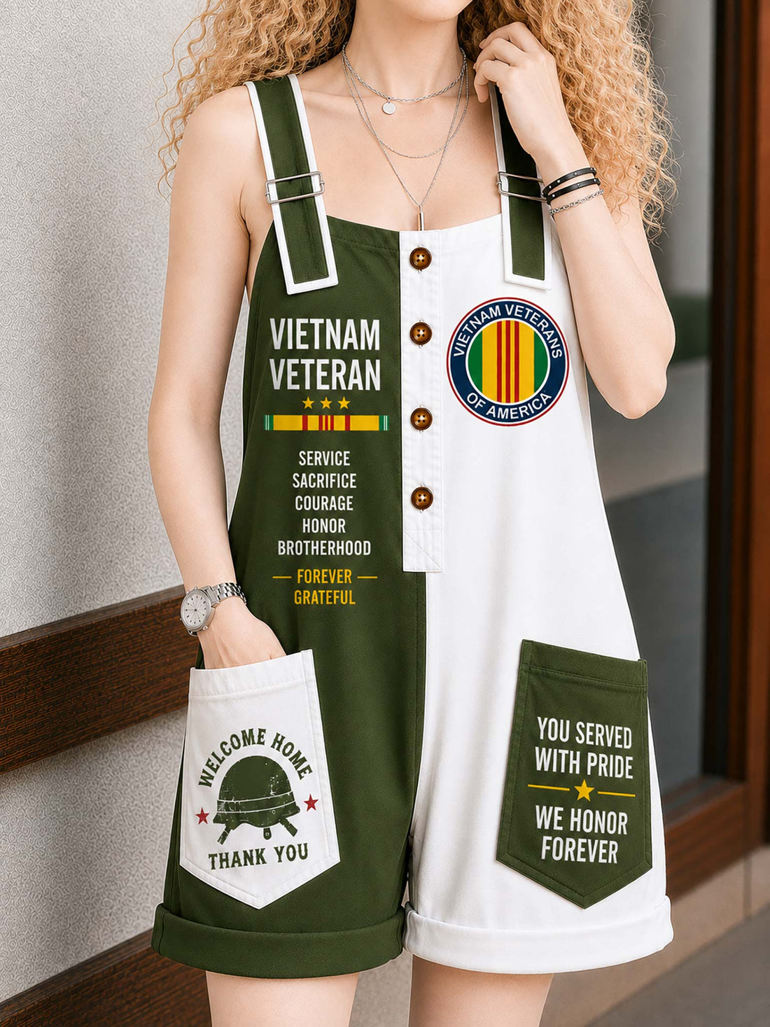 A woman wearing a sleeveless military-themed romper with green and white panels, front buttons, and patriotic Vietnam War graphics including 'VIETNAM VETERAN' and 'YOU SERVED WITH PRIDE WE HONOR FOREVER'.