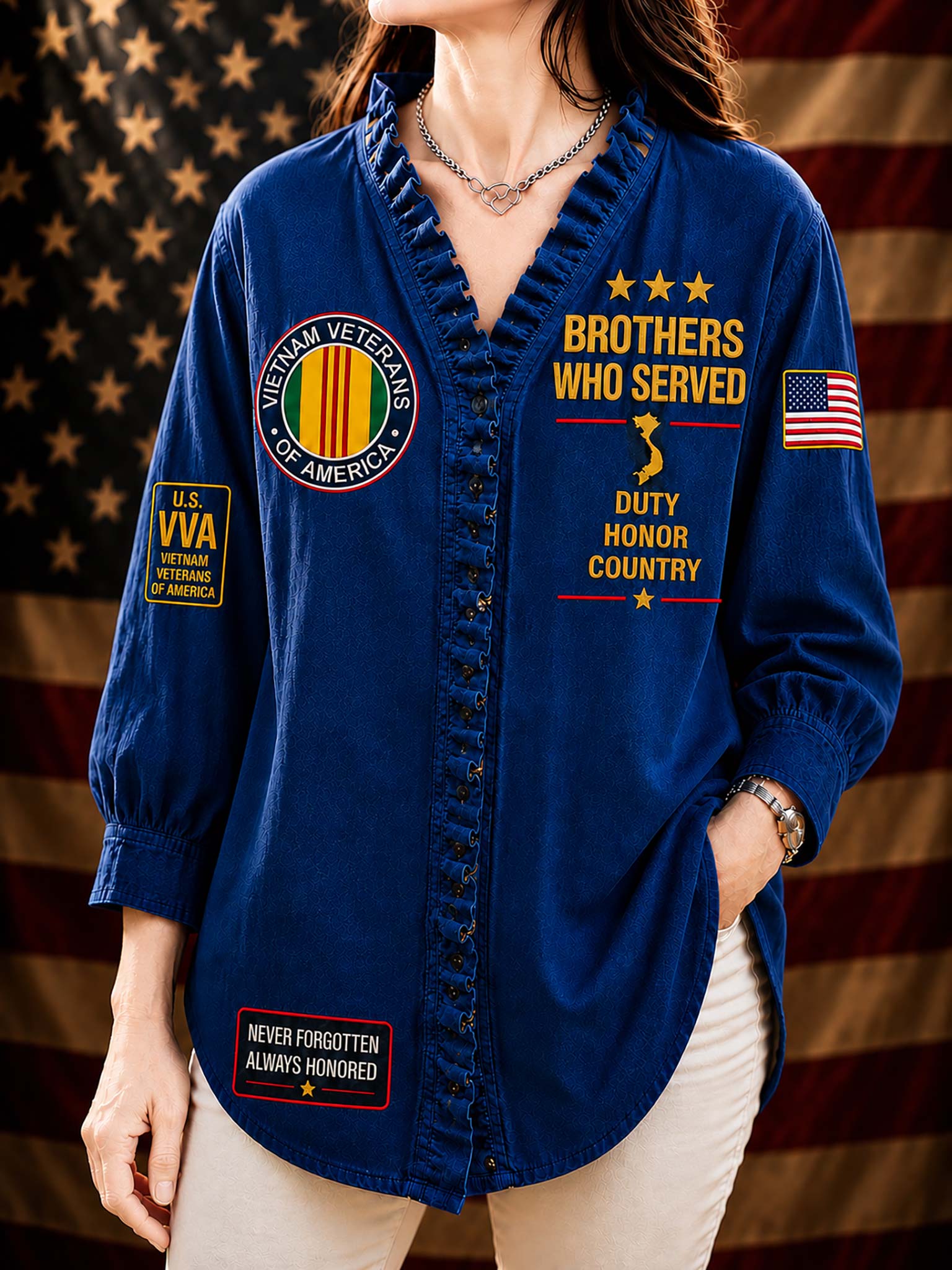 A woman wearing a royal blue button-up shirt with military-themed graphics, including 'Brothers Who Served,' 'Vietnam Veterans of America,' and 'U.S.