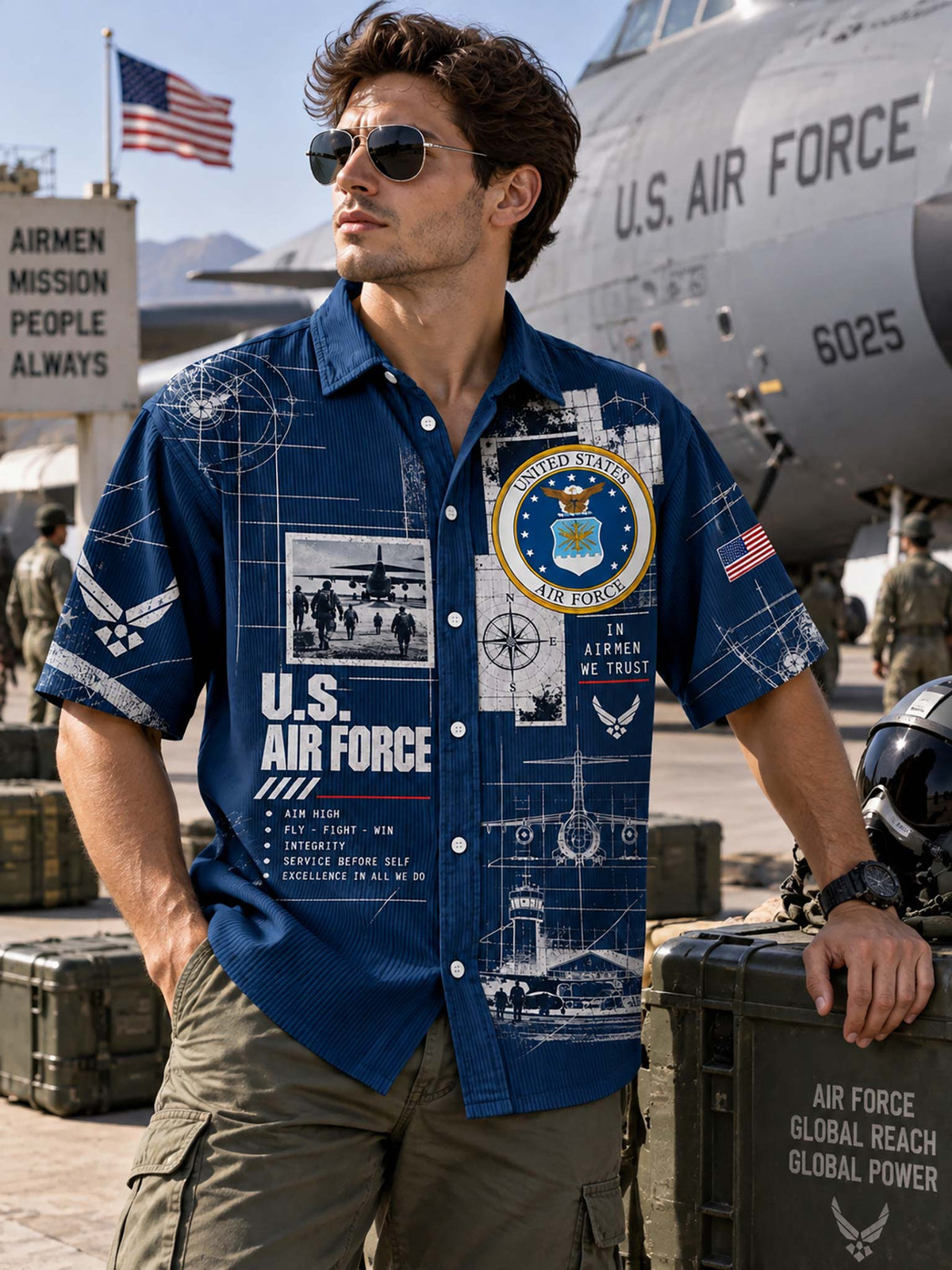 A man wearing a blue short-sleeve button-up shirt with U.S.