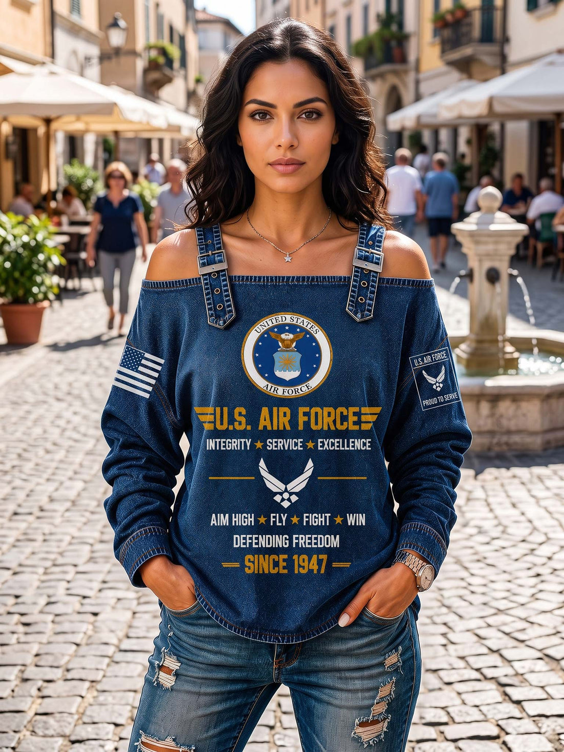 A woman wearing a blue off-the-shoulder denim long-sleeve top with a large U.S.