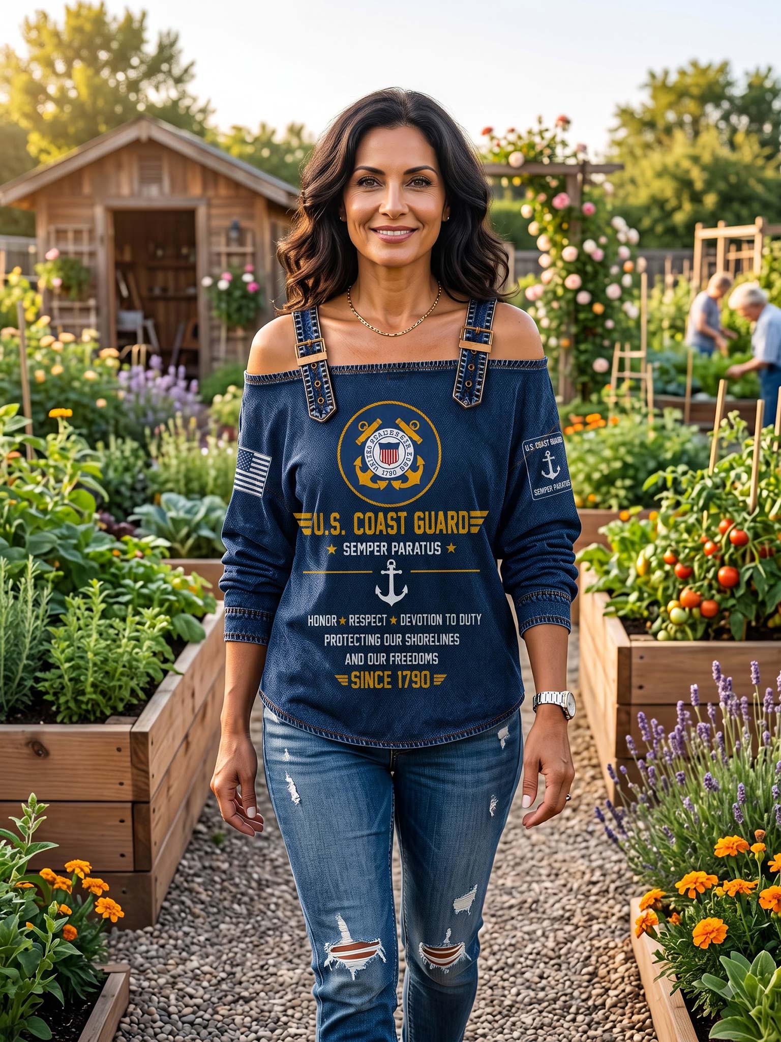 A woman stands in a sunny garden wearing a navy blue long-sleeve top with a U.S.