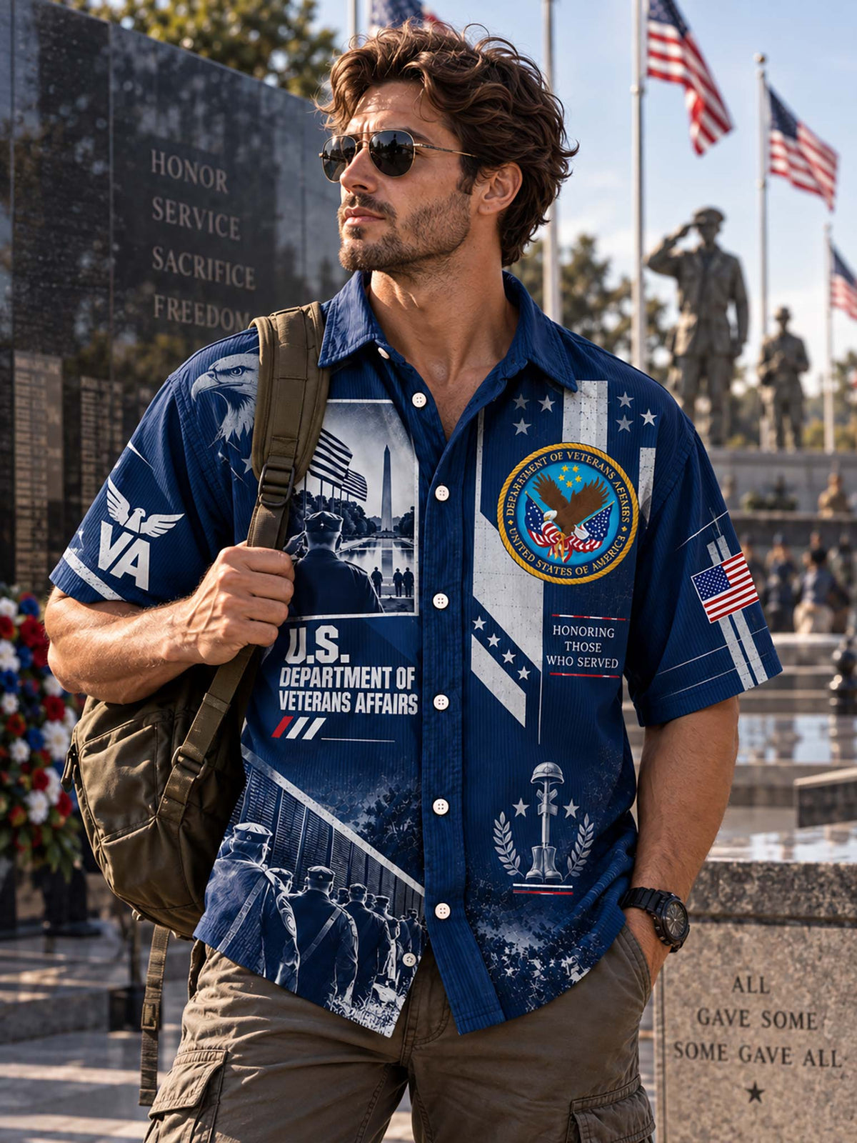 A man wearing a blue short-sleeve button-up shirt with military-themed graphics, including 'U.S.
