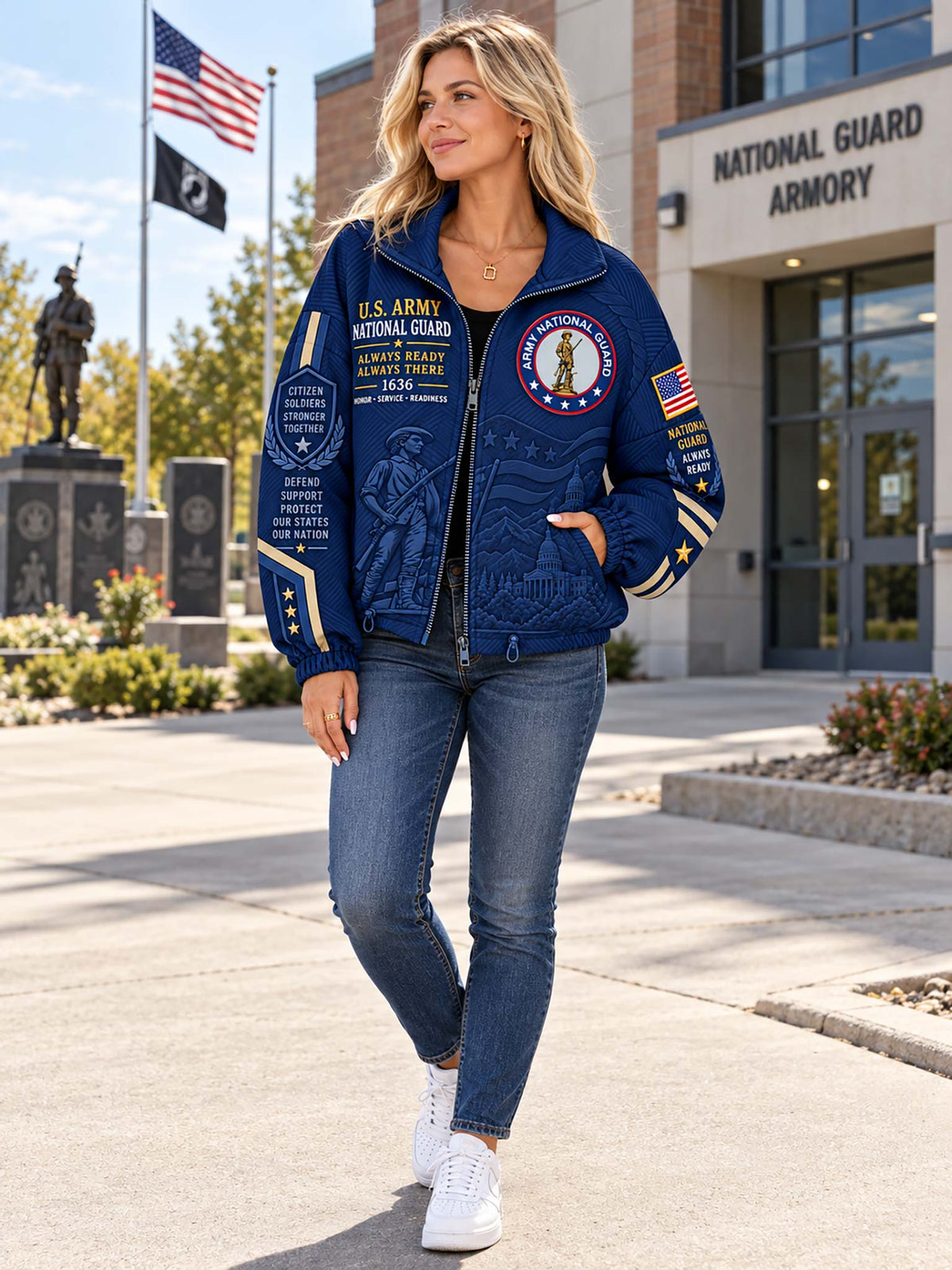 A woman stands outdoors in front of the National Guard Armory wearing a navy blue U.S.