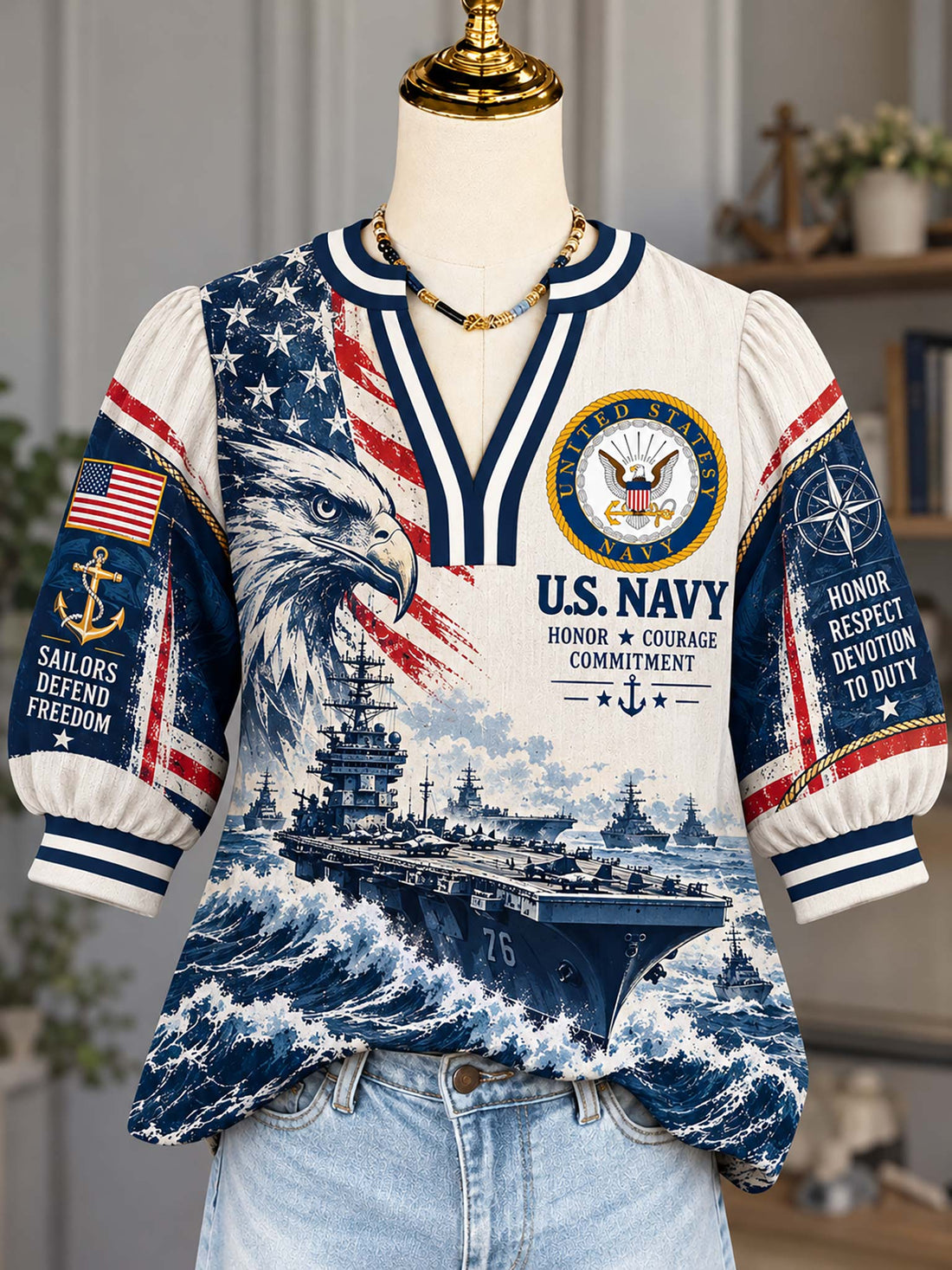 A short-sleeve V-neck top displayed on a mannequin torso, featuring a U.S.