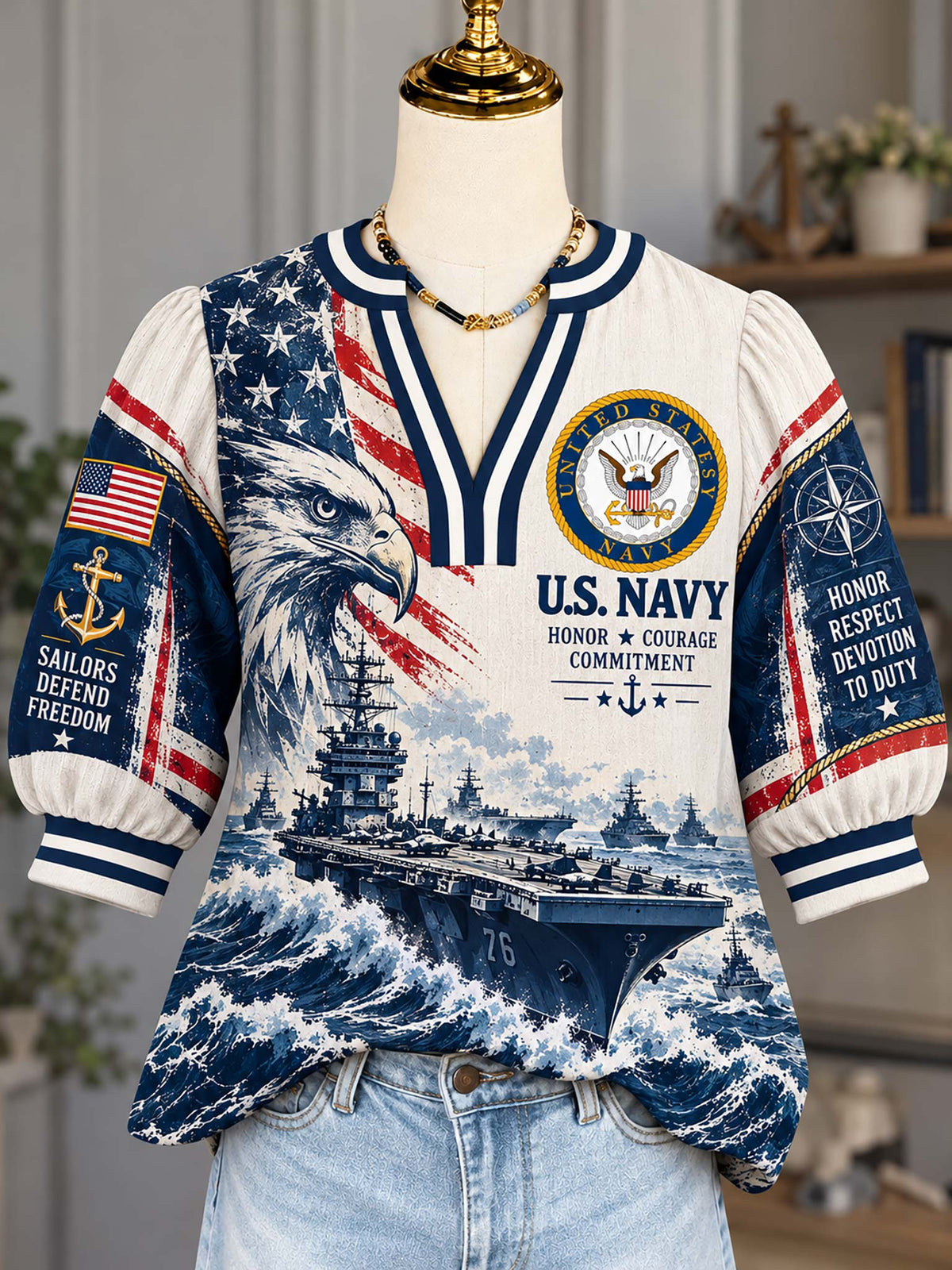 A short-sleeve V-neck top displayed on a mannequin torso, featuring a U.S.