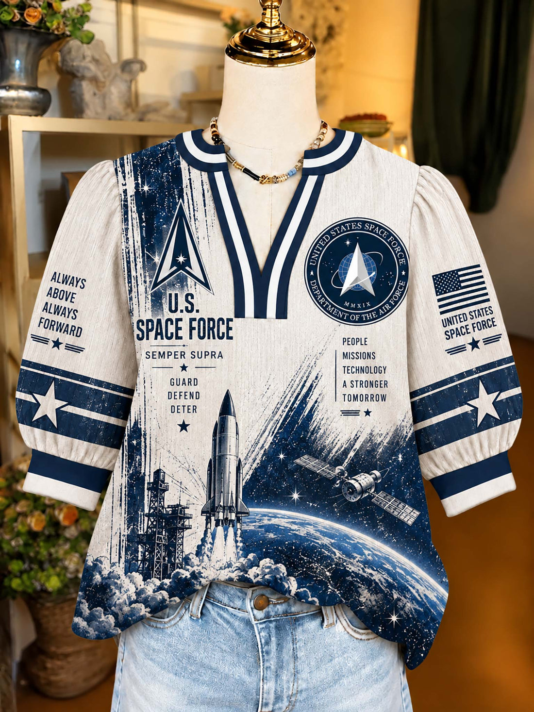 A short-sleeve V-neck top displayed on a mannequin torso, featuring a U.S.