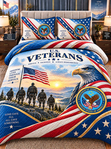 A patriotic bedding set displayed on a bed in a styled bedroom. The set includes a comforter and two matching pillowcases featuring a large U.