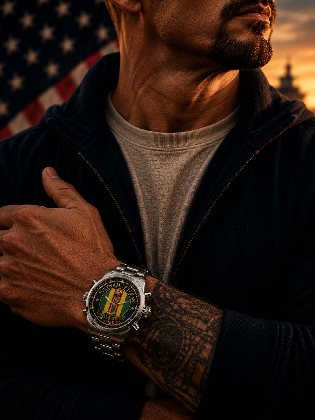 A stainless steel wristwatch with a large round dial featuring a Vietnam Veteran emblem, set against a blurred American flag background on a wooden surface.